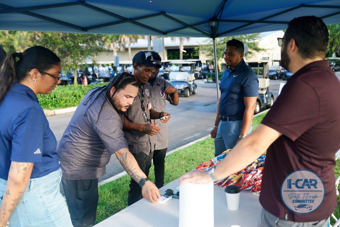 Volunteers at the check-in table of the 28th South Florida I-CAR Golf Tournament