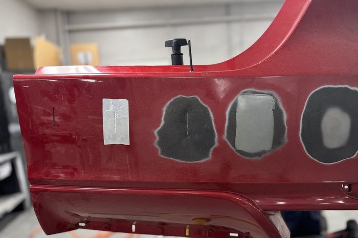A repair panel set up on a stand in the shop for collision practice