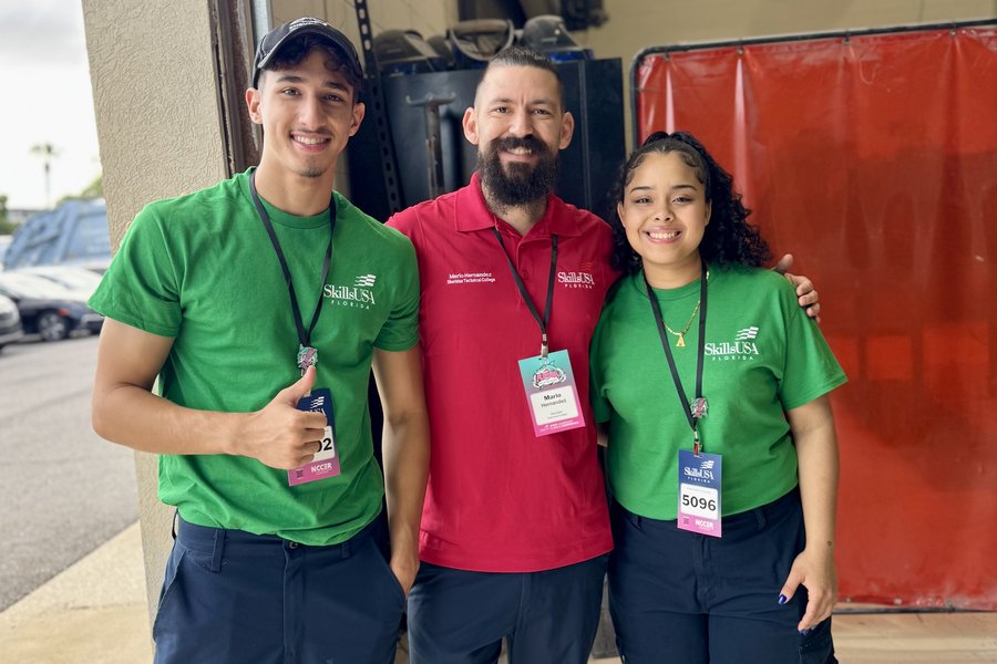Two collision students with their instructor at the SkillsUSA Florida conference